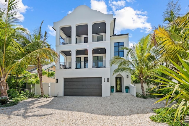 109 Palmetto Ave, Anna Maria, FL 34216 - view of front of house featuring a balcony, a gate, driveway, and stucco siding
