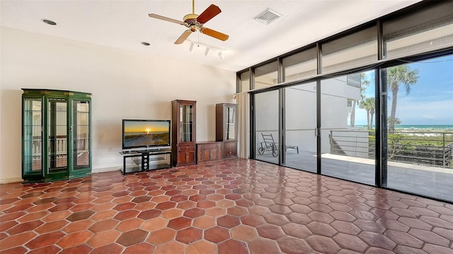 222 Beach Rd Unit 7, Sarasota, FL 34242 - unfurnished living room with a ceiling fan, track lighting, and a towering ceiling