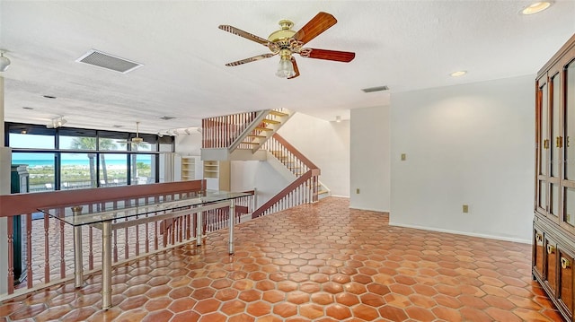 222 Beach Rd Unit 7, Sarasota, FL 34242 - spare room featuring a ceiling fan, a textured ceiling, recessed lighting, and stairs