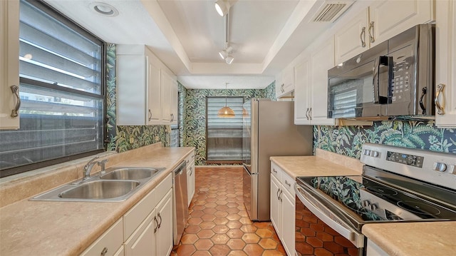 222 Beach Rd Unit 7, Sarasota, FL 34242 - kitchen with stainless steel appliances, white cabinetry, and light countertops