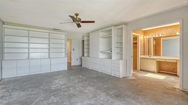 222 Beach Rd Unit 7, Sarasota, FL 34242 - unfurnished bedroom with concrete flooring, a textured ceiling, connected bathroom, and a ceiling fan