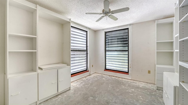 222 Beach Rd Unit 7, Sarasota, FL 34242 - unfurnished bedroom featuring a textured ceiling, unfinished concrete flooring, and ceiling fan