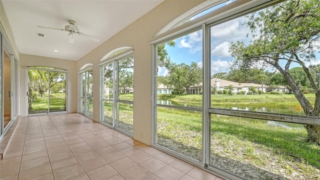 3317 Highlands Bridge Rd Unit 61, Sarasota, FL 34235 - unfurnished sunroom featuring a water view, tile patterned floors, and healthy amount of natural light