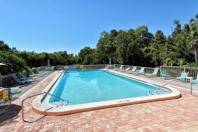 137 Woodland Pl, Osprey, FL 34229 - community pool featuring a patio area and view of scattered trees