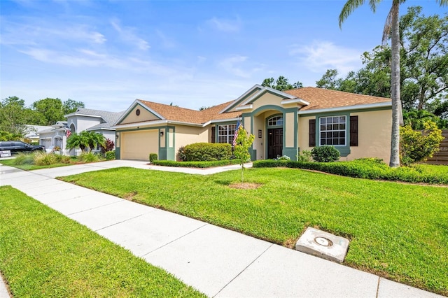 743 Stonecrest Dr, Sarasota, FL 34232 - ranch-style home with stucco siding, driveway, a front yard, and a garage