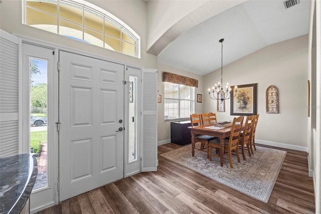 743 Stonecrest Dr, Sarasota, FL 34232 - foyer entrance with vaulted ceiling, a chandelier, dark wood-style floors, baseboards, and healthy amount of natural light