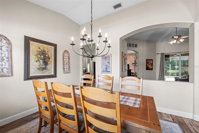 743 Stonecrest Dr, Sarasota, FL 34232 - dining room featuring arched walkways, vaulted ceiling, wood finished floors, baseboards, and a ceiling fan