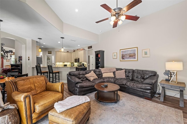 743 Stonecrest Dr, Sarasota, FL 34232 - living room featuring ceiling fan, wood finished floors, arched walkways, recessed lighting, and baseboards