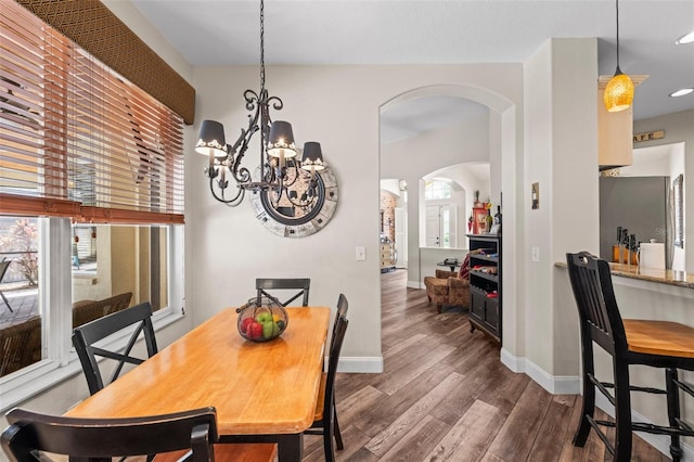 743 Stonecrest Dr, Sarasota, FL 34232 - dining room with arched walkways, a chandelier, dark wood finished floors, baseboards, and recessed lighting