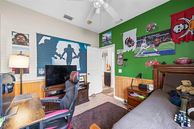 743 Stonecrest Dr, Sarasota, FL 34232 - bedroom with wainscoting, an office area, wood finished floors, wooden walls, and a ceiling fan