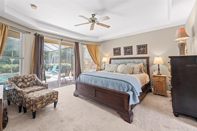 743 Stonecrest Dr, Sarasota, FL 34232 - bedroom featuring a raised ceiling, access to exterior, light colored carpet, and a ceiling fan