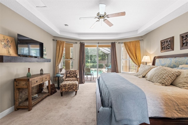 743 Stonecrest Dr, Sarasota, FL 34232 - bedroom with access to outside, light carpet, a tray ceiling, and baseboards