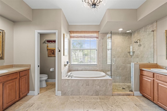 743 Stonecrest Dr, Sarasota, FL 34232 - bathroom featuring a shower stall, two vanities, a bath, toilet, and baseboards