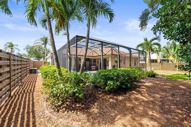 743 Stonecrest Dr, Sarasota, FL 34232 - rear view of property featuring a fenced backyard and glass enclosure