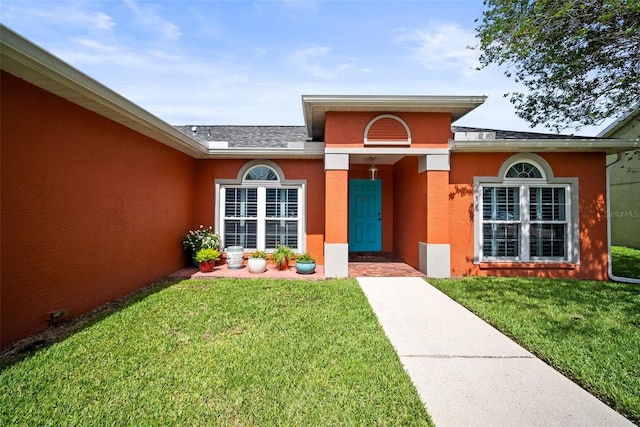 4194 Banbury Cir, Parrish, FL 34219 - entrance to property with a lawn and stucco siding