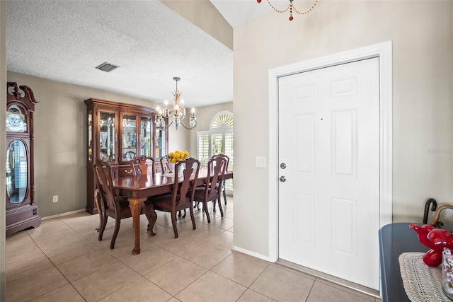 4194 Banbury Cir, Parrish, FL 34219 - dining space featuring a chandelier, light tile patterned flooring, baseboards, and a textured ceiling