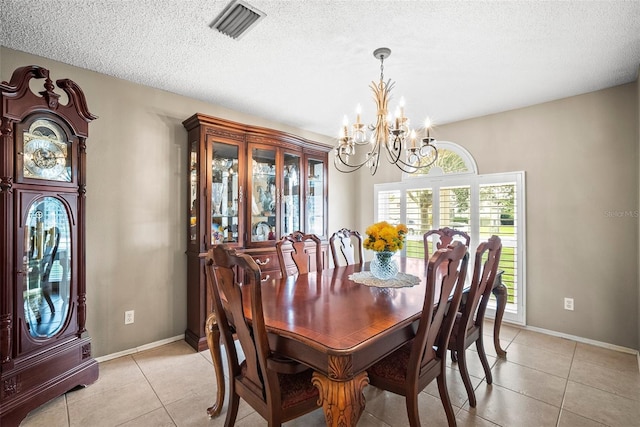 4194 Banbury Cir, Parrish, FL 34219 - dining area with a chandelier, light tile patterned floors, baseboards, and a textured ceiling