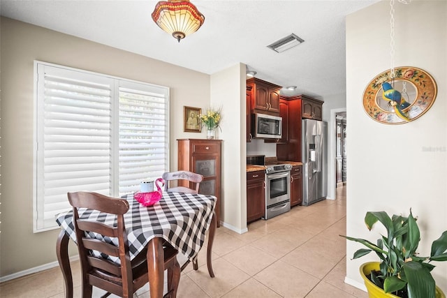 4194 Banbury Cir, Parrish, FL 34219 - dining area featuring light tile patterned floors and baseboards