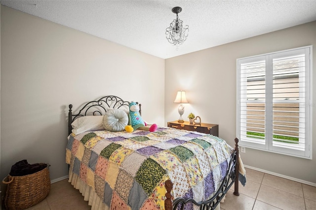 4194 Banbury Cir, Parrish, FL 34219 - bedroom featuring multiple windows, tile patterned floors, baseboards, and a textured ceiling