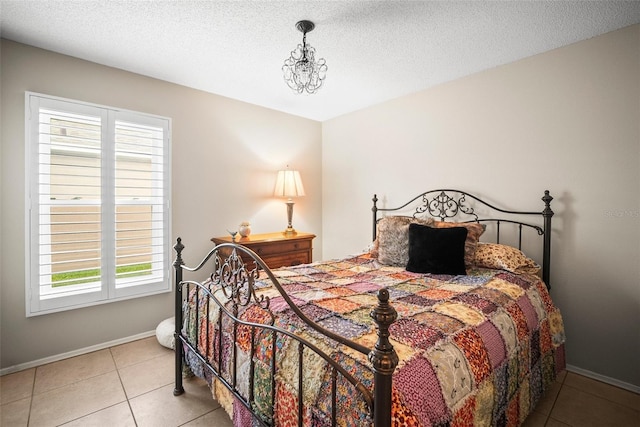 4194 Banbury Cir, Parrish, FL 34219 - bedroom featuring multiple windows, tile patterned floors, baseboards, and a textured ceiling