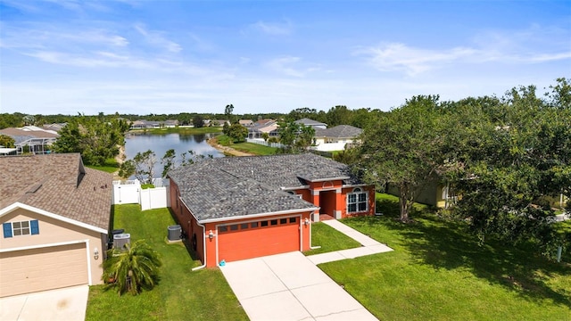 4194 Banbury Cir, Parrish, FL 34219 - view of front of property with a water view, concrete driveway, a garage, a residential view, and central AC