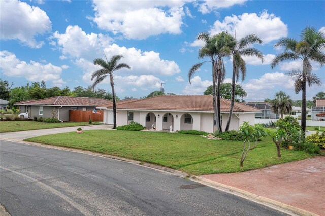 107 Van Dyck Dr, Nokomis, FL 34275 - view of front of property featuring driveway, a tiled roof, stucco siding, and an attached garage
