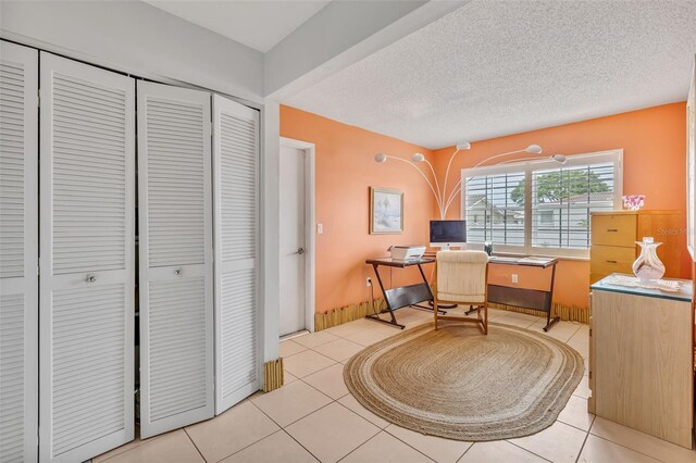 107 Van Dyck Dr, Nokomis, FL 34275 - home office featuring light tile patterned flooring and a textured ceiling