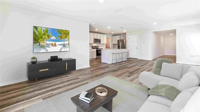 12064 Lansing Gln, Parrish, FL 34219 - living room with wood finished floors, baseboards, and recessed lighting