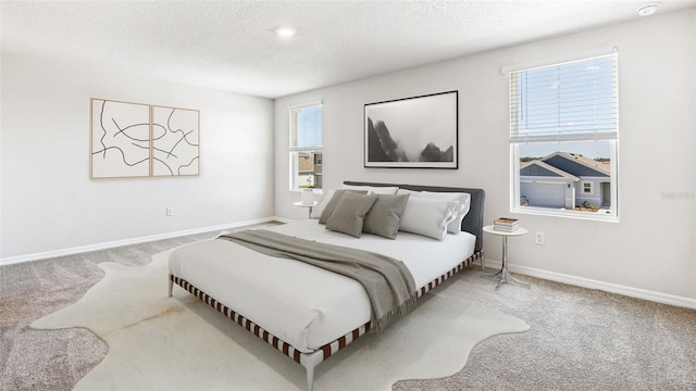 12064 Lansing Gln, Parrish, FL 34219 - bedroom with carpet floors, a textured ceiling, and baseboards