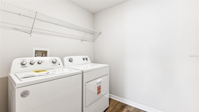 12064 Lansing Gln, Parrish, FL 34219 - washroom featuring washing machine and clothes dryer, dark wood-type flooring, and baseboards