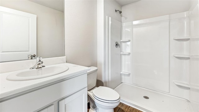 12064 Lansing Gln, Parrish, FL 34219 - full bathroom featuring vanity, toilet, a shower, and wood finished floors