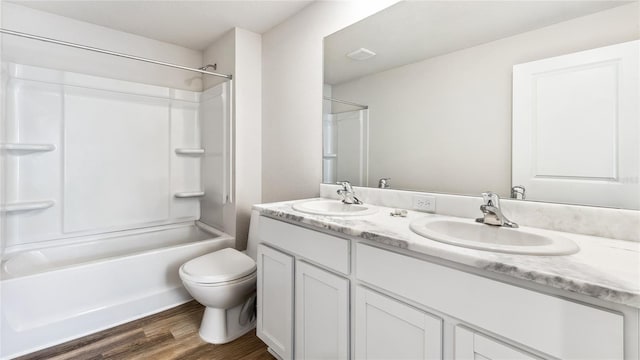 12064 Lansing Gln, Parrish, FL 34219 - full bathroom with double vanity, toilet, bathing tub / shower combination, and wood finished floors
