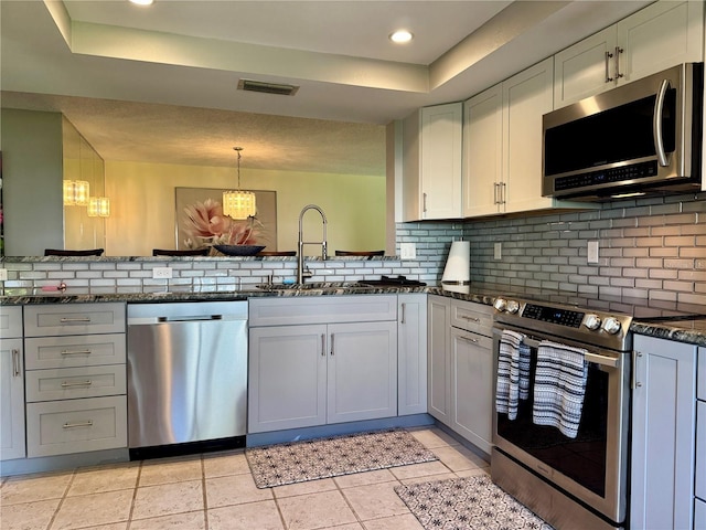 3500 El Conquistador Pkwy Unit 347, Bradenton, FL 34210 - kitchen with appliances with stainless steel finishes, a raised ceiling, tasteful backsplash, and recessed lighting