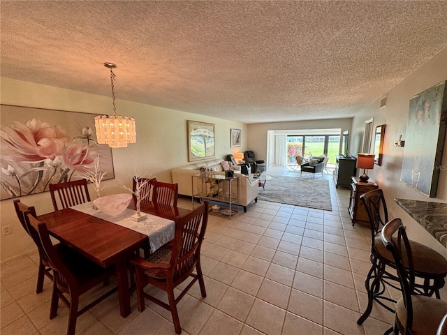 3500 El Conquistador Pkwy Unit 347, Bradenton, FL 34210 - dining room with light tile patterned floors, a chandelier, and a textured ceiling