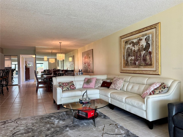 3500 El Conquistador Pkwy Unit 347, Bradenton, FL 34210 - living room with tile patterned flooring, a textured ceiling, and a chandelier
