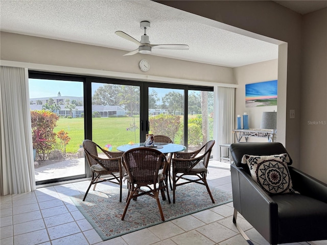 3500 El Conquistador Pkwy Unit 347, Bradenton, FL 34210 - dining area with ceiling fan, a textured ceiling, and light tile patterned floors