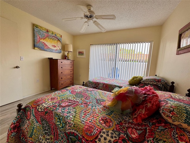 3500 El Conquistador Pkwy Unit 347, Bradenton, FL 34210 - bedroom with wood finished floors, access to outside, a textured ceiling, and a ceiling fan