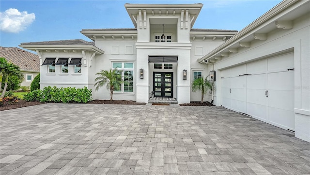 8537 Pavia Way, Bradenton, FL 34202 - view of exterior entry with decorative driveway, stucco siding, french doors, and an attached garage