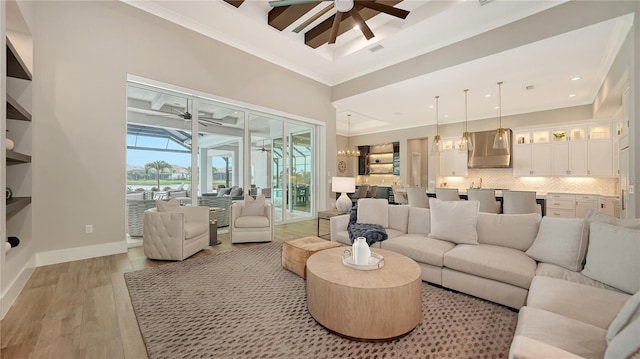 8537 Pavia Way, Bradenton, FL 34202 - living room featuring ceiling fan, crown molding, light wood-type flooring, a towering ceiling, and recessed lighting