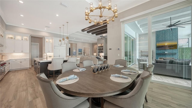 8537 Pavia Way, Bradenton, FL 34202 - dining room featuring a ceiling fan, recessed lighting, crown molding, light wood-style flooring, and a chandelier
