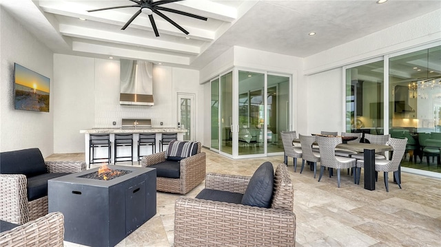 8537 Pavia Way, Bradenton, FL 34202 - view of patio with an outdoor living space with a fire pit, exterior kitchen, ceiling fan, and outdoor dining area