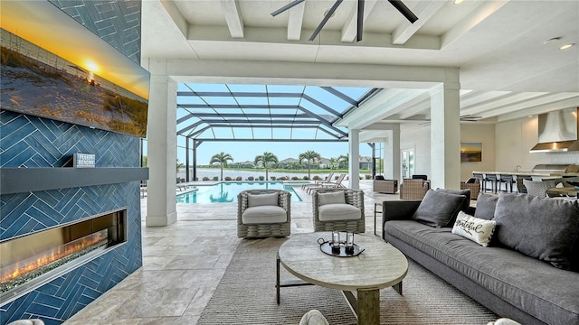 8537 Pavia Way, Bradenton, FL 34202 - living room with beam ceiling, a tile fireplace, and a water view
