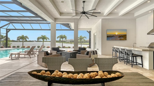 8537 Pavia Way, Bradenton, FL 34202 - view of patio / terrace featuring a fire pit, a water view, glass enclosure, an outdoor pool, and a ceiling fan