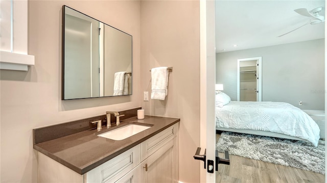 8537 Pavia Way, Bradenton, FL 34202 - bathroom with vanity, connected bathroom, wood finished floors, and recessed lighting