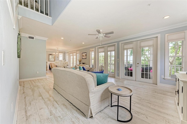 8963 Fishermens Bay Dr, Sarasota, FL 34231 - living room featuring french doors, ornamental molding, plenty of natural light, a chandelier, and ceiling fan
