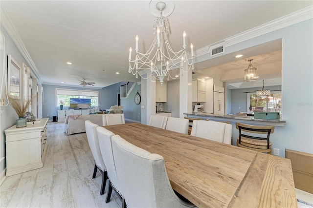 8963 Fishermens Bay Dr, Sarasota, FL 34231 - dining space featuring a chandelier, ceiling fan, ornamental molding, recessed lighting, and light wood-style flooring