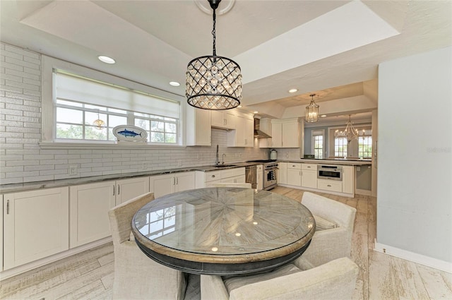 8963 Fishermens Bay Dr, Sarasota, FL 34231 - dining room featuring a chandelier, a tray ceiling, and recessed lighting