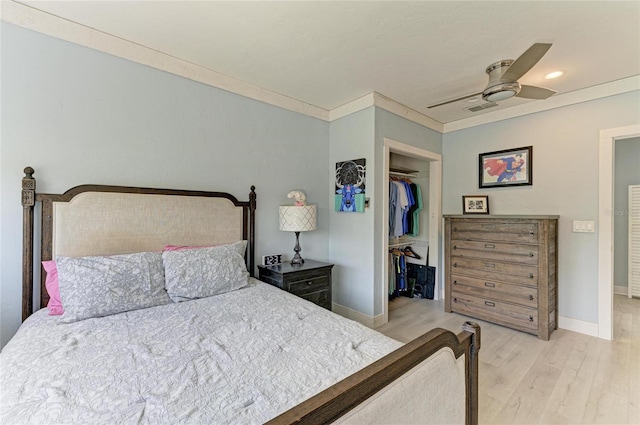 8963 Fishermens Bay Dr, Sarasota, FL 34231 - bedroom featuring wood finished floors, a closet, ceiling fan, ornamental molding, and a walk in closet