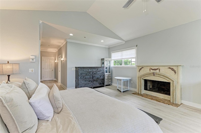8963 Fishermens Bay Dr, Sarasota, FL 34231 - bedroom with vaulted ceiling, light wood finished floors, a fireplace, ornamental molding, and a ceiling fan