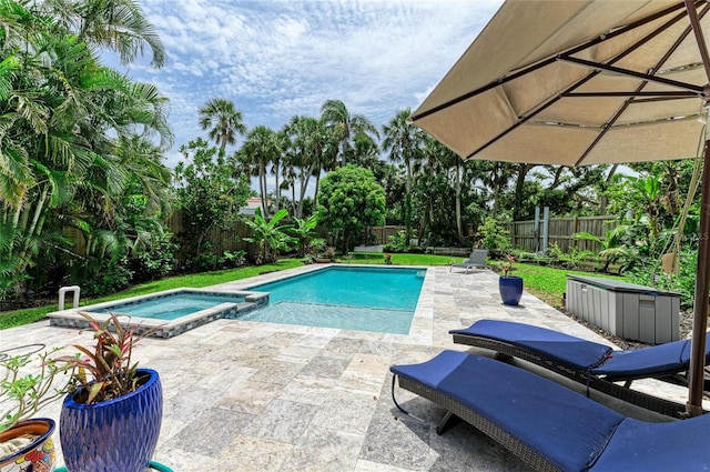 8963 Fishermens Bay Dr, Sarasota, FL 34231 - view of swimming pool featuring a patio area, a fenced backyard, and a pool with connected hot tub